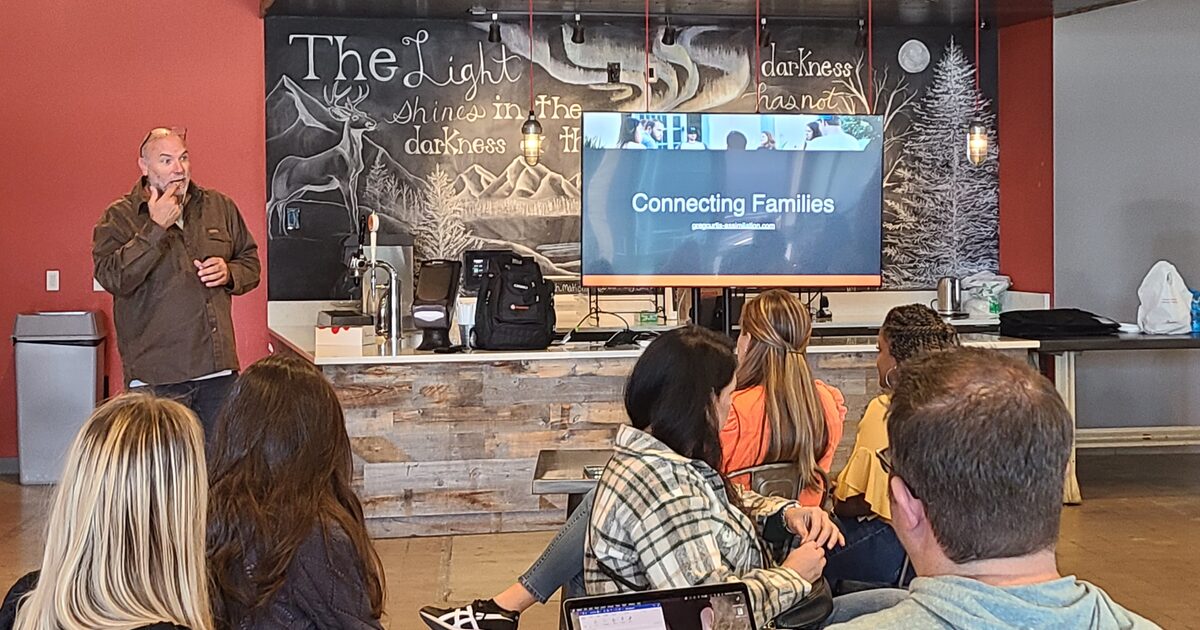 A ministry leader speaking with a room of volunteers